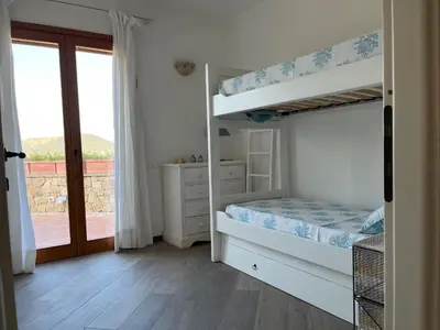 Letto o letti in una camera di Chia Villa Violet