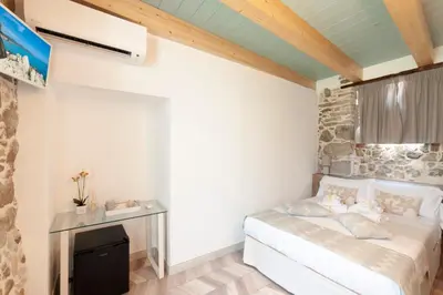 Letto o letti in una camera di PERDAS ROOMS