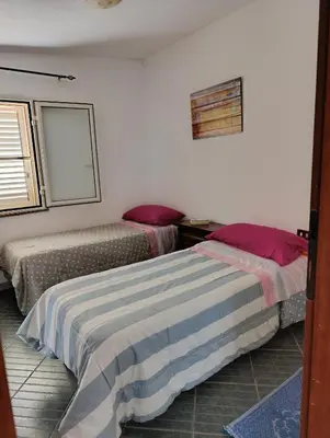 Letto o letti in una camera di Casa Caterina