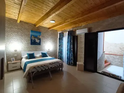 Letto o letti in una camera di Domos La Corte Ghibellina