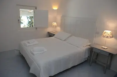 Letto o letti in una camera di SUL MARE SARDEGNA VILLA MERCEDES