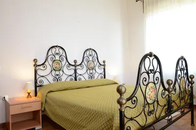 Letto o letti in una camera di Villa Orrì