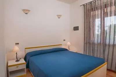 Letto o letti in una camera di Residence Il Vascello