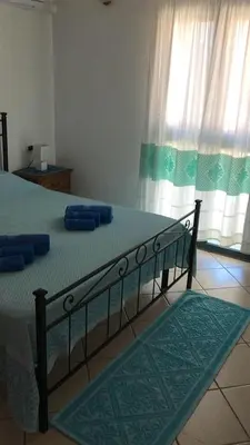 Letto o letti in una camera di CAMY Apartment Scopri Tortolì Appartamento Centrale vicino alle Spiagge!