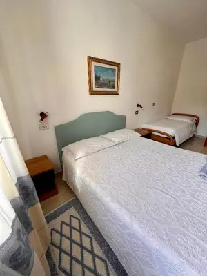 Letto o letti in una camera di Hotel La Capannina