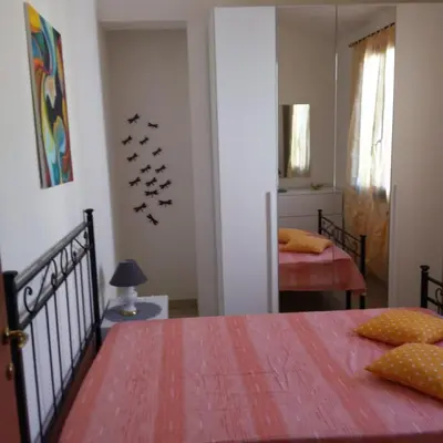 Letto o letti in una camera di Casa vacanze Antonella Pula a 750mt dal centro.