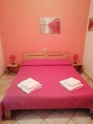 Letto o letti in una camera di B&B Bella Calasetta