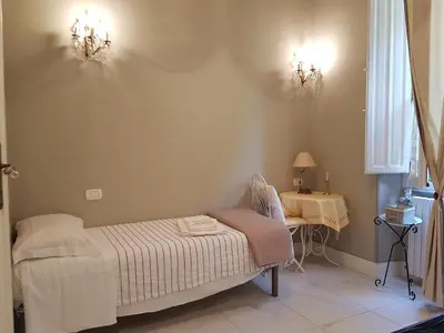 Letto o letti in una camera di VILLA LIBERTY OFELIA locazioni brevi