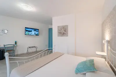 Letto o letti in una camera di Angolo Mare Apartments & Rooms