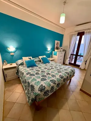 Letto o letti in una camera di casa Wela