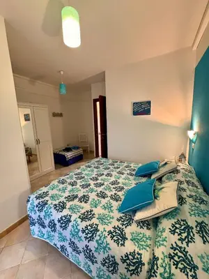 Letto o letti in una camera di casa Wela