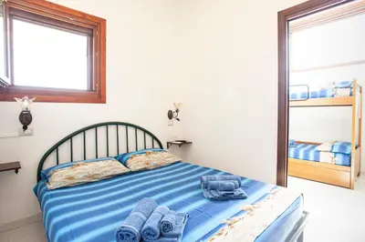 Letto o letti in una camera di Arcobaleno 1