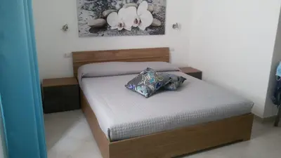 Letto o letti in una camera di Mio & Tuyo Casa Vacanze