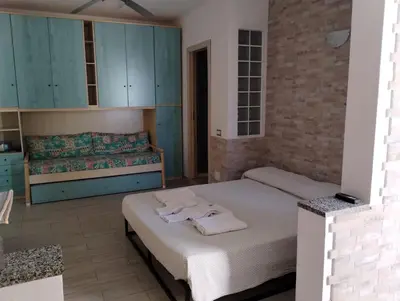Letto o letti in una camera di Costa Rei Free Beach Residence Alloggio a un passo dal mare di Sardegna