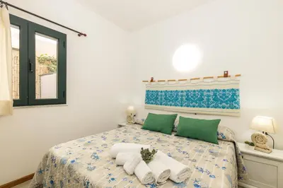 Letto o letti in una camera di Casa Perla Marina