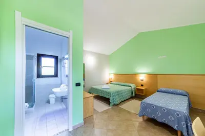 Letto o letti in una camera di Agriturismo Is Cortillaris