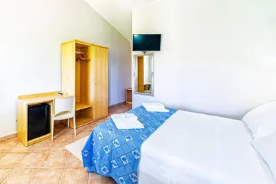 Letto o letti in una camera di Agriturismo Is Cortillaris