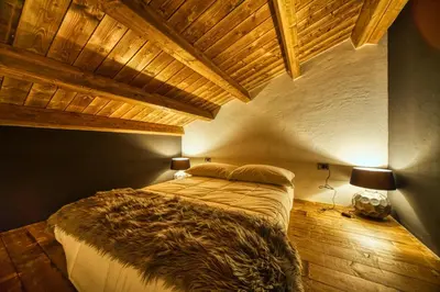 Letto o letti in una camera di BAITA MAORE luxury rooms & Spa