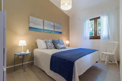 Letto o letti in una camera di Casa Azzurra - Casa con giardino privato a Costa Rei a due passi dal mare