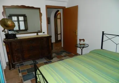 Letto o letti in una camera di CASA CON VERANDA A POCHI PASSI DAL MARE