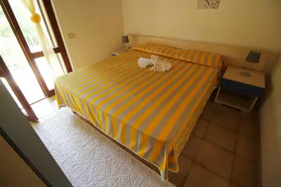 Letto o letti in una camera di Villetta Turagri a soli 300m dalla spiaggia 4 camere da letto