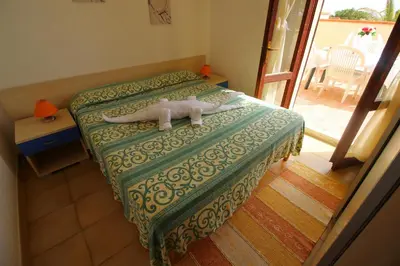 Letto o letti in una camera di Villetta Turagri a soli 300m dalla spiaggia 4 camere da letto