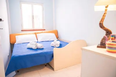Letto o letti in una camera di Casa Josto a due passi da Spiaggia Maladroxia