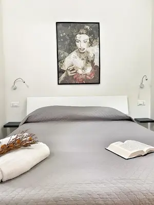 Letto o letti in una camera di DOMOBLU Camere In Centro