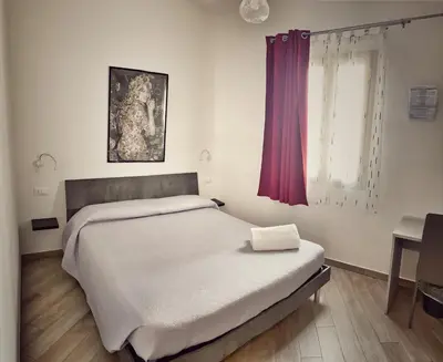 Letto o letti in una camera di DOMOBLU Camere In Centro