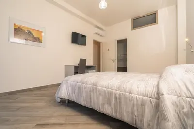 Letto o letti in una camera di DOMOBLU Camere In Centro