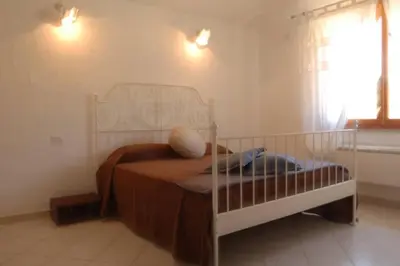 Letto o letti in una camera di Chia Delizioso nido verde nel blu
