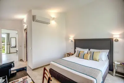 Letto o letti in una camera di Cala Sinzias Resort