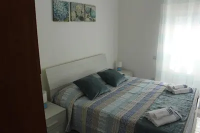 Letto o letti in una camera di Smile - appartamento con giardino