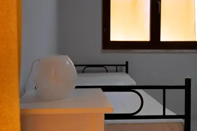 Letto o letti in una camera di Villetta Simiri caposchiera con cortile e BBQ