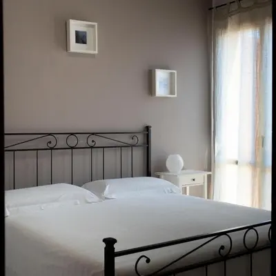 Letto o letti in una camera di Villetta Simiri caposchiera con cortile e BBQ