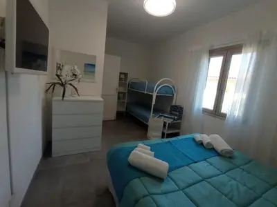 Letto o letti in una camera di Casa Antonella, a due passi dalla spiaggia, Total relax