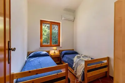 Letto o letti in una camera di VILLA ROSANNA