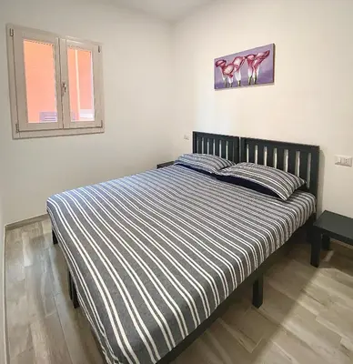 Letto o letti in una camera di Torre dei Corsari APPARTAMENTO CON GIARDINO VISTA MARE