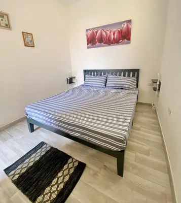 Letto o letti in una camera di Torre dei Corsari APPARTAMENTO CON GIARDINO VISTA MARE