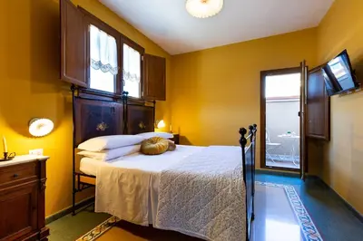 Letto o letti in una camera di B&B ANTICA KALAGONIS