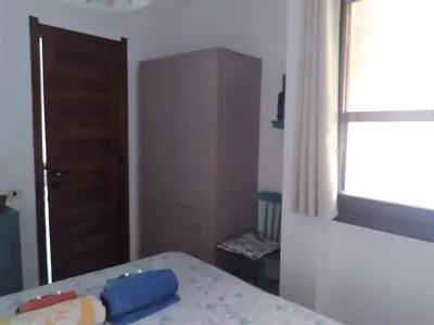 Letto o letti in una camera di Casa vacanza - Pinus Village Casa margherita a Pula-Chia - a 350 m a piedi dalla spiaggia più vicina, a 5 minuti in auto dalle spiagge di Chia ed a 15 minuti in auto dalla splendida spiaggia di Tuerredda