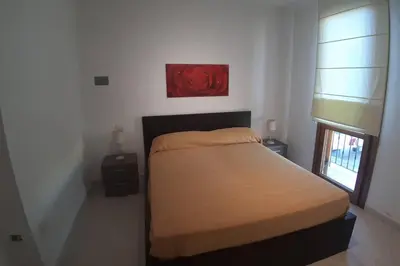 Letto o letti in una camera di Casetta Emma, trilocale Elmas, areoporto elegante silenzioso