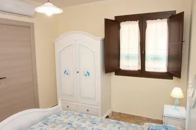 Letto o letti in una camera di Villa Elisa residenza Agorà Villasimius