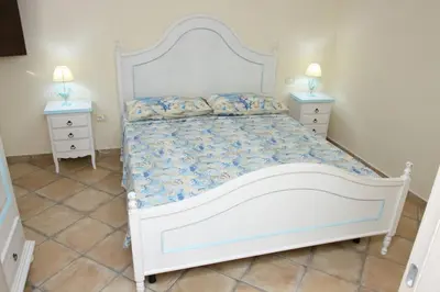 Letto o letti in una camera di Villa Elisa residenza Agorà Villasimius