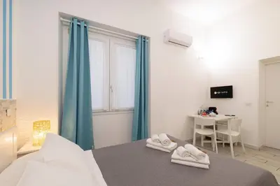 Letto o letti in una camera di Approdo Rooms - Eja Sardinia