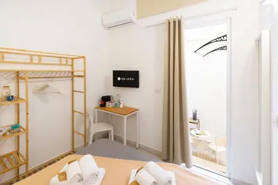Letto o letti in una camera di Approdo Rooms - Eja Sardinia