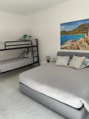 Letto o letti in una camera di B&B Bentu de Mari
