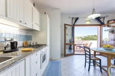 Cucina o angolo cottura di Costa Verde, Torre dei Corsari with a terrace overlooking the sea and close to the pristine dunes