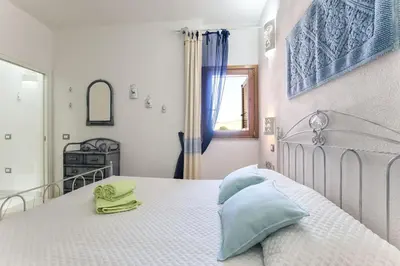 Letto o letti in una camera di Costa Verde, Torre dei Corsari with a terrace overlooking the sea and close to the pristine dunes