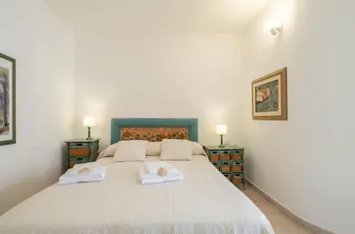 Letto o letti in una camera di ⭑⭑⭑⭑⭑La perla Rosa nel centro storico a Carloforte